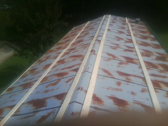Rusted metal roof panels with new wood purlins before replacement — Storm Damage Roof Repair in South Portland by Roofing Brothers